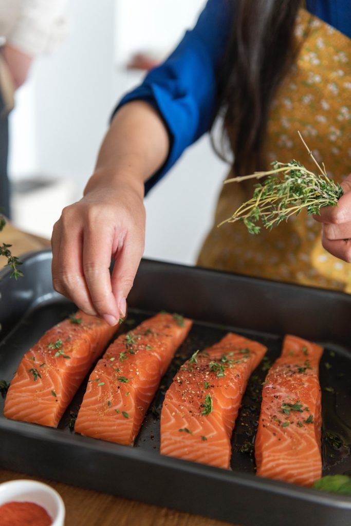 girl cooking salmon